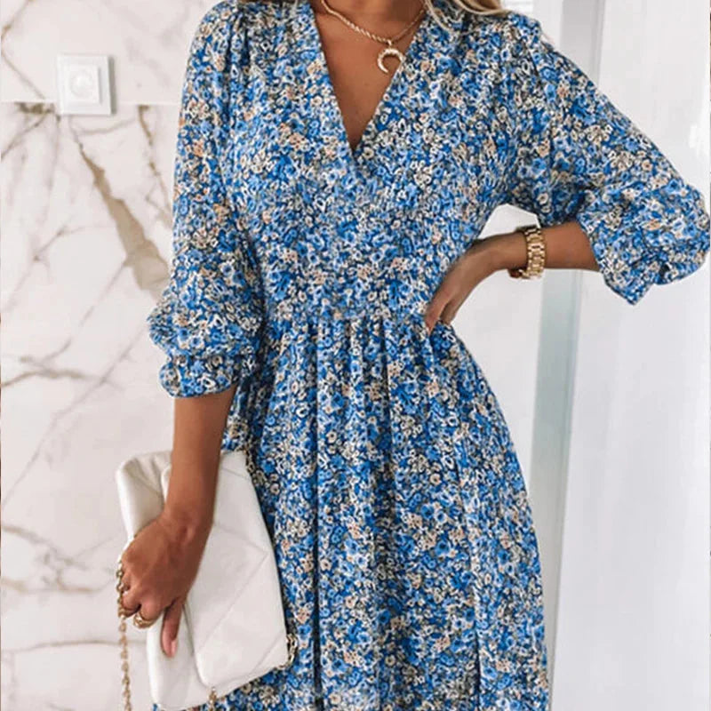 Blue v-neck floral Boho dress featuring a relaxed fit and lightweight fabric with delicate floral print, perfect for casual…