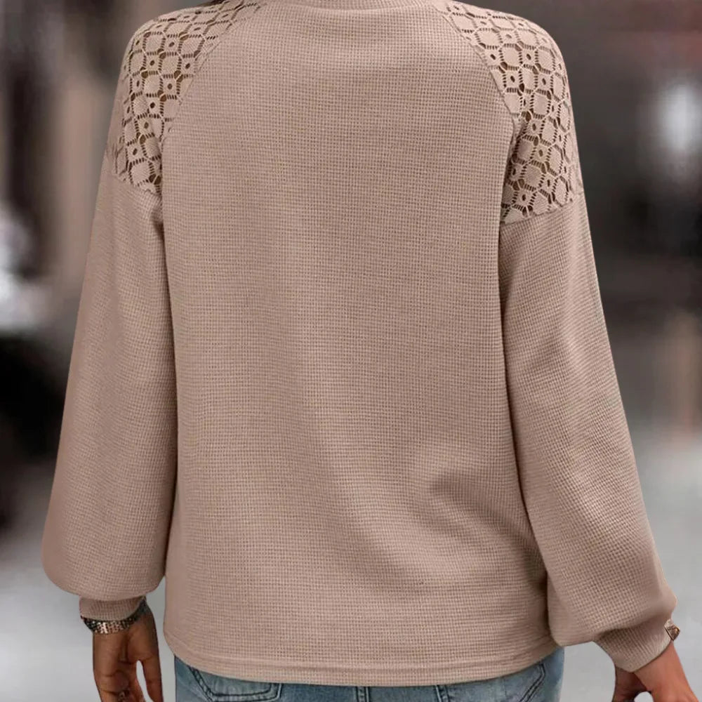 Beige sweater with lace shoulder detail, a cozy and stylish addition to your wardrobe.