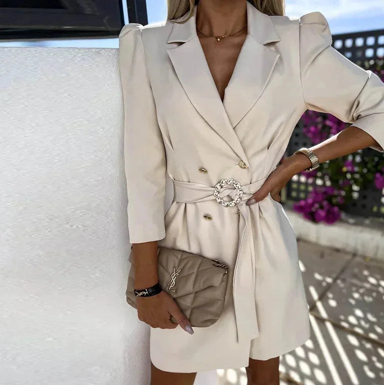 Cream double-breasted dress with belt made of soft cotton blend. Features a classic design with a modern twist for a…