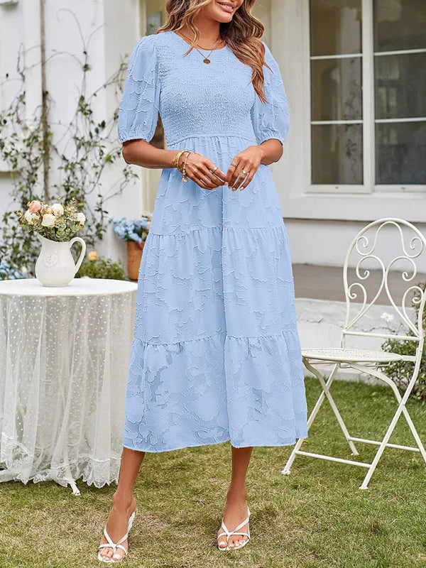 Blue tiered midi dress with textured detail, perfect for summer days.