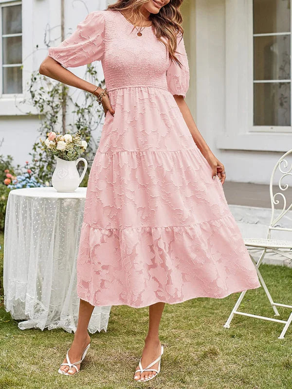 Pink midi dress with tiered textured design. Soft and flowy fabric makes it perfect for any occasion.