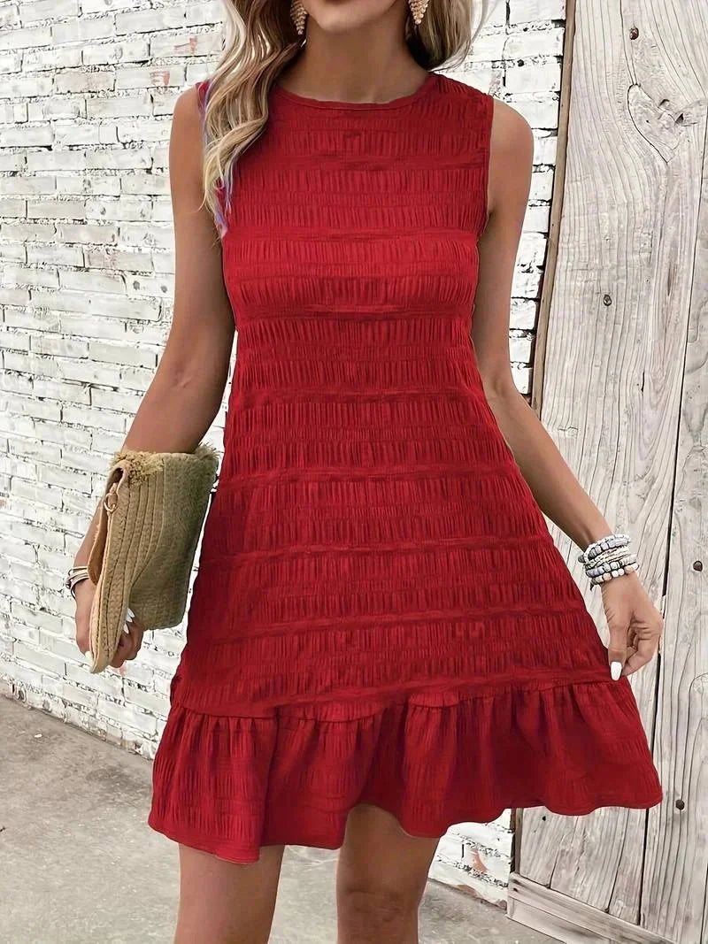 Red sleeveless dress with textured fabric and ruffle hem, perfect for a stylish and chic look for any occasion.