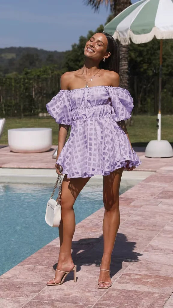 Off-shoulder purple mini dress with puff sleeves, made of flowing fabric. Perfect for a casual yet stylish look.