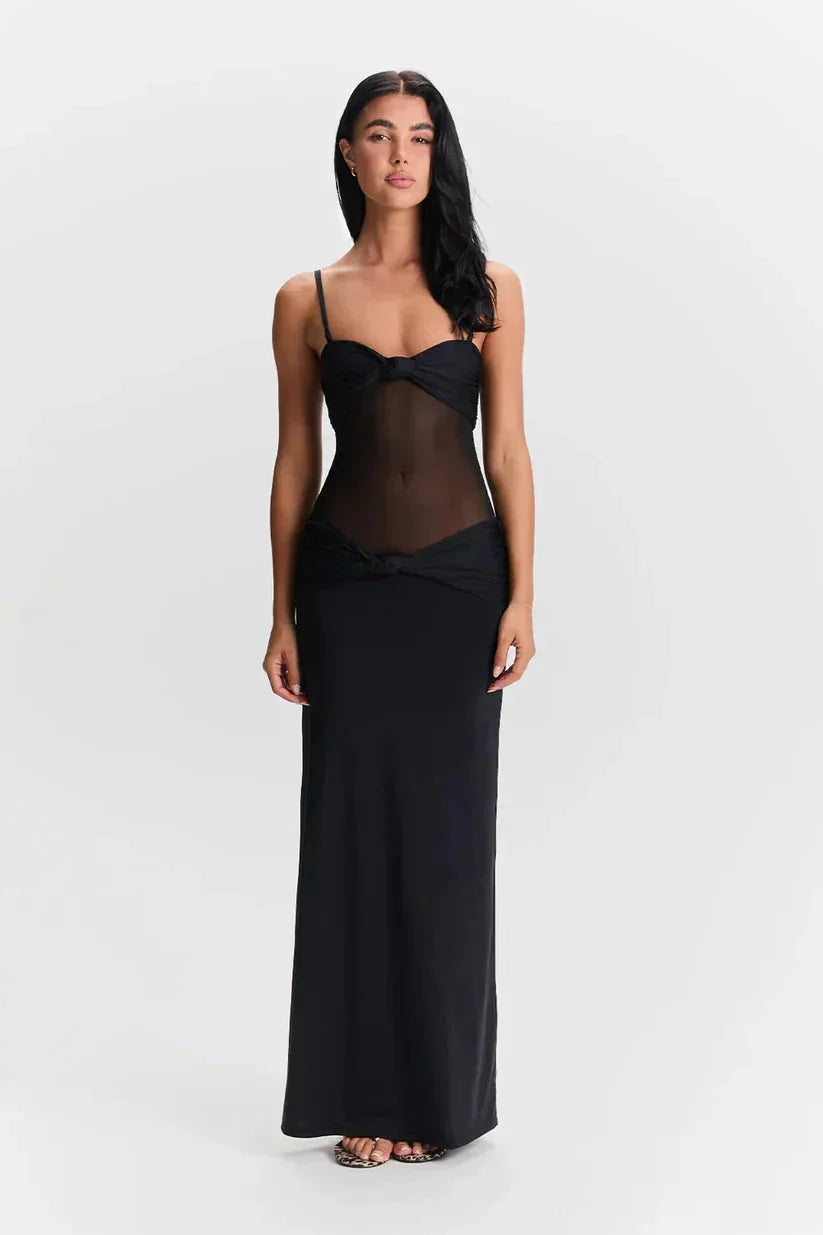 Black strapless maxi dress with sheer detail for women. Sleeveless design with a flowy silhouette, perfect for a chic…