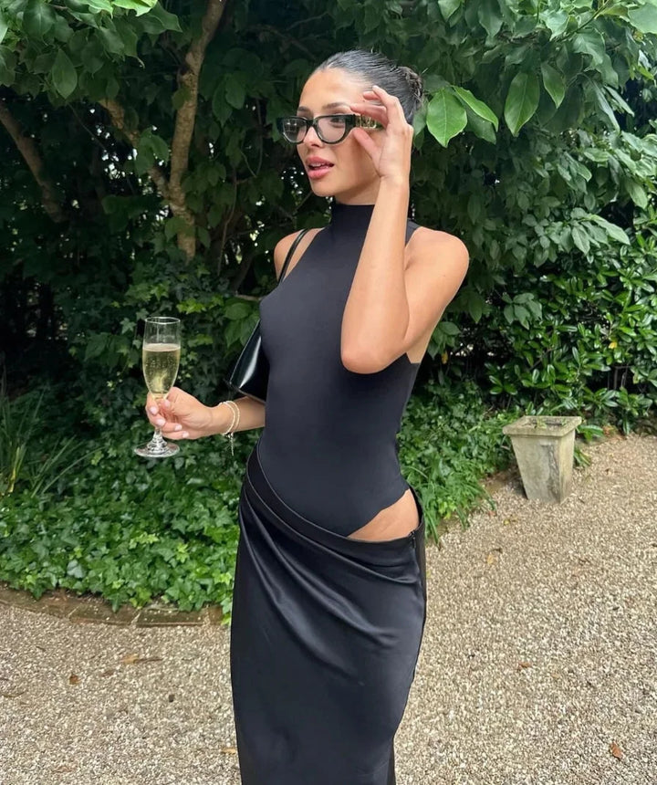"Sleeveless halter neck dress with side slits in a soft and flowy fabric, perfect for a casual yet stylish look."