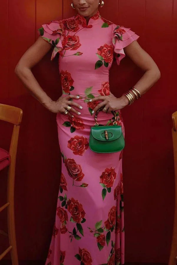Pink floral maxi dress with high neckline and ruffled sleeves, ideal for a chic and feminine look.