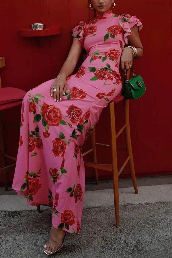 Pink maxi dress with floral print, high neckline, and ruffled sleeves. Feminine and elegant summer outfit for any occasion.
