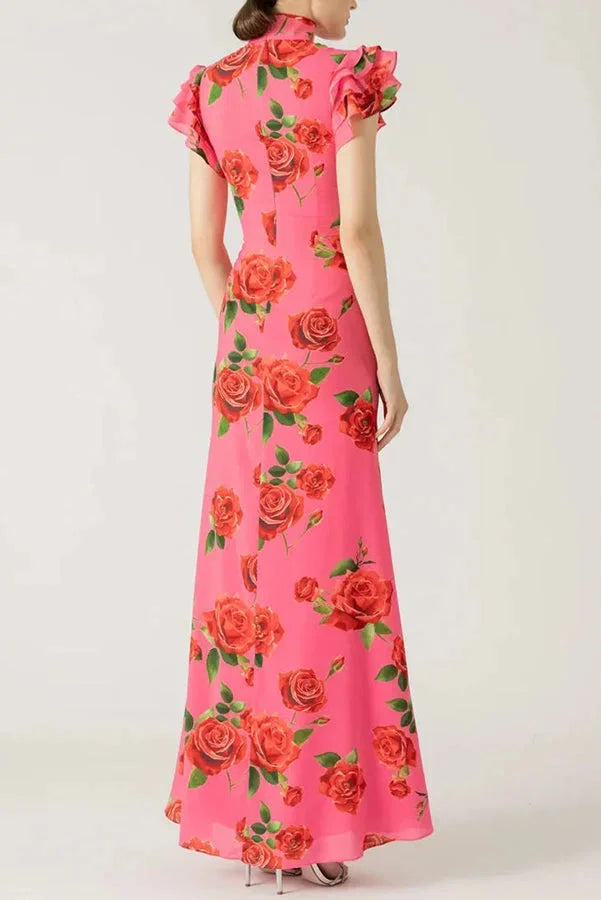Pink maxi dress with floral print, high neckline, and ruffled sleeves. Soft and flowy fabric perfect for summer outings.