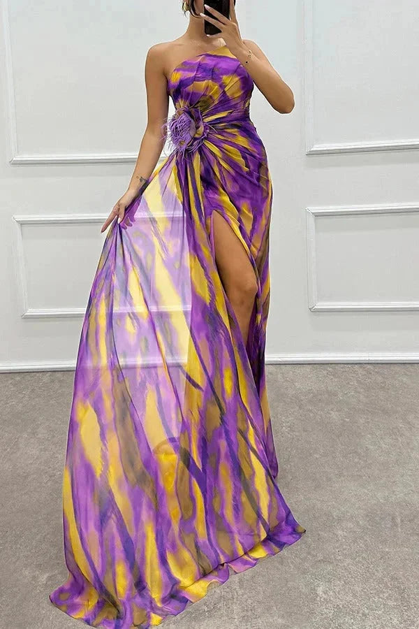 "Women's maxi dress in soft fabric with elegant floral accent and front slit, ideal for casual or formal wear."