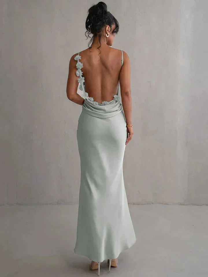 Pale green maxi dress with open back for women, showcasing a delicate and elegant design.
