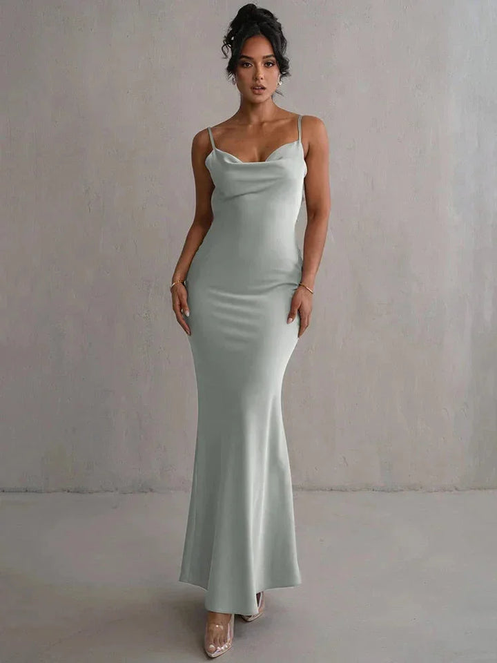 "Women's pale green maxi dress with an elegant open back design, perfect for a summer day. Soft and flowy fabric for a…