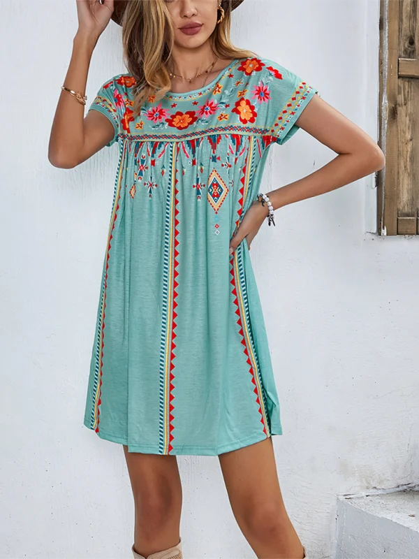 Green bohemian dress with intricate floral embroidery on soft cotton fabric, inspired by Cleopatra's timeless style.