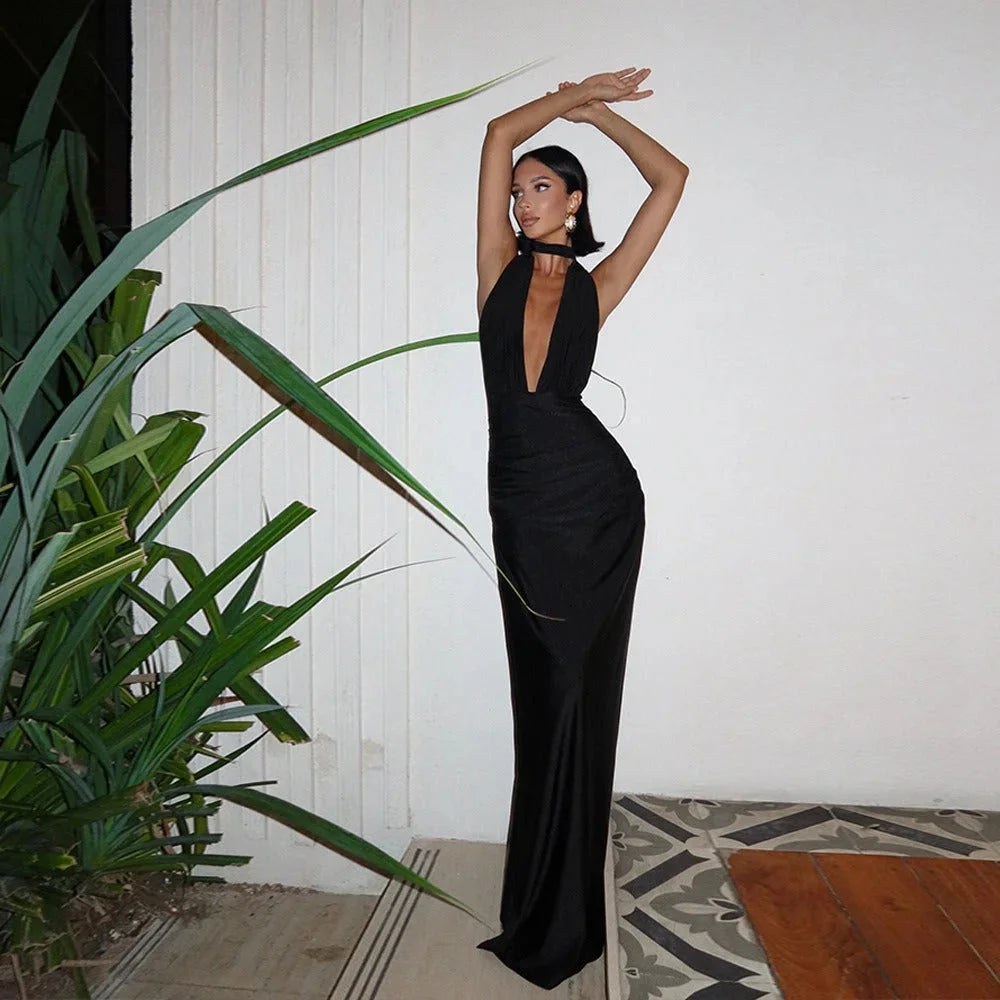 White halterneck maxi dress with a fitted silhouette. Perfect for sunny days with its sleek design and breathable material.