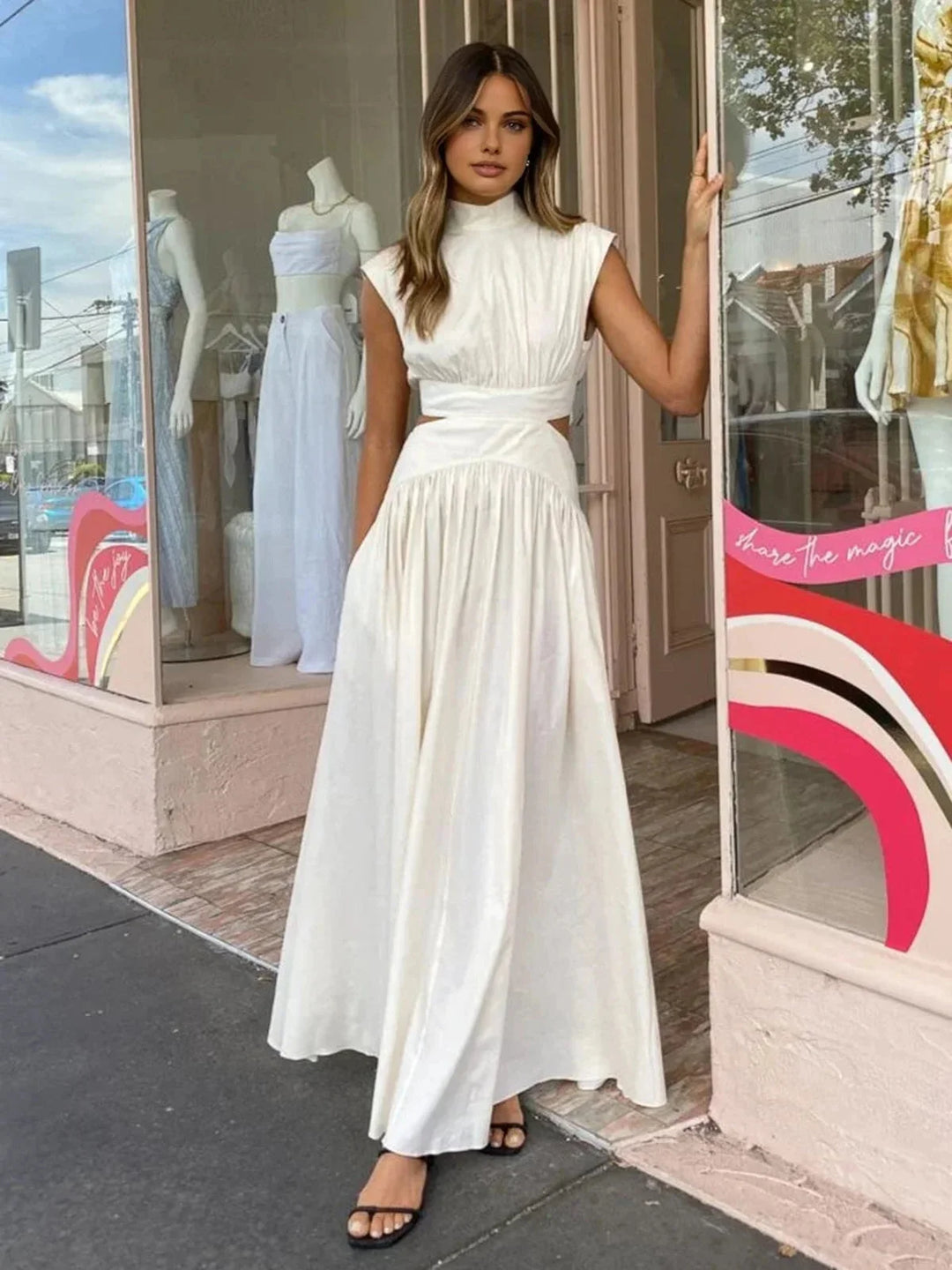 Sleeveless mock neck dress with cutouts in soft, breathable fabric, perfect for a chic and stylish look.
