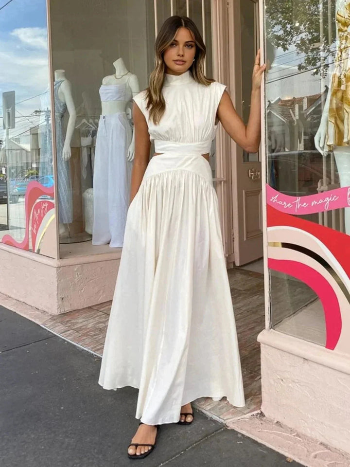 Sleeveless mock neck dress with cutouts in soft, breathable fabric, perfect for a chic and stylish look.