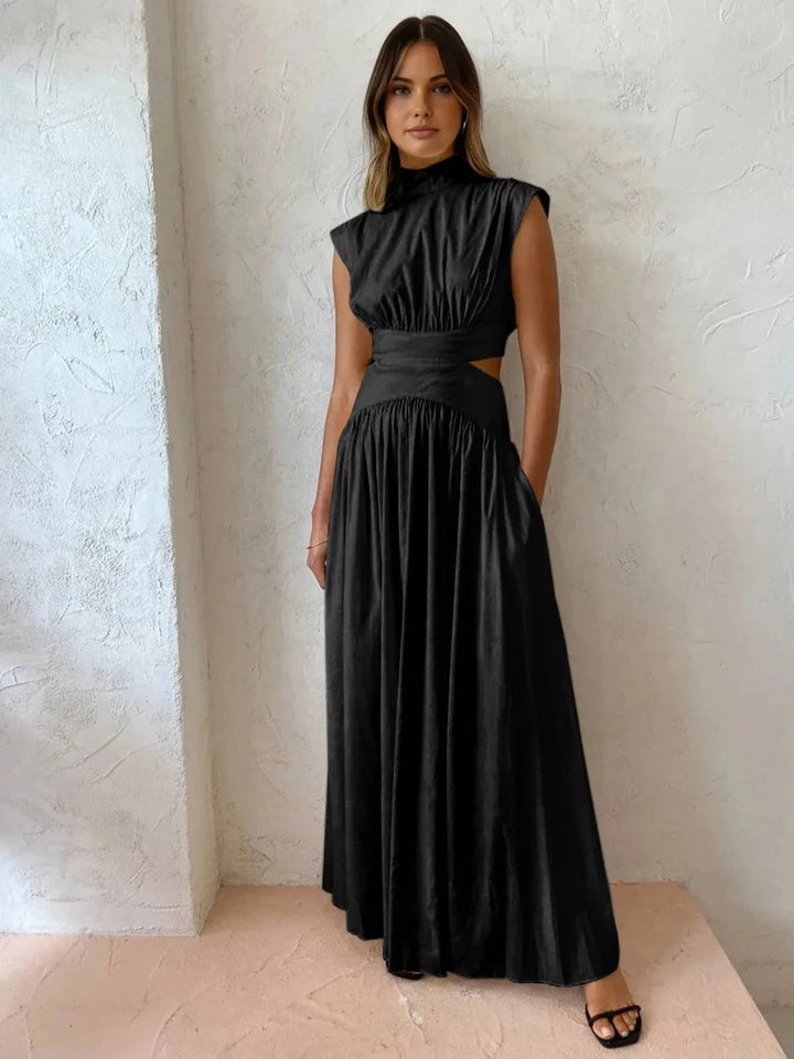 Black sleeveless mock neck dress with cutouts, showcasing a modern design and soft, breathable fabric for a chic and…