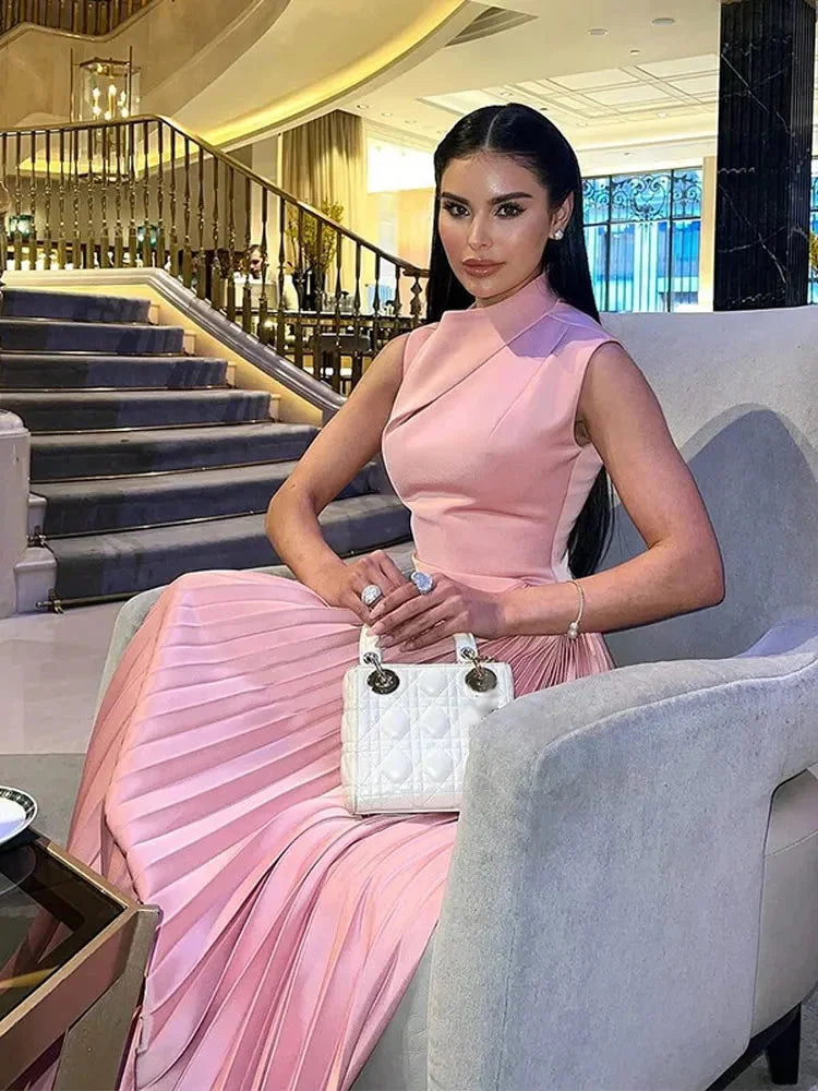 "Sleeveless pink maxi dress with pleated detail, ideal for summer outings, made from breathable and lightweight fabric."
