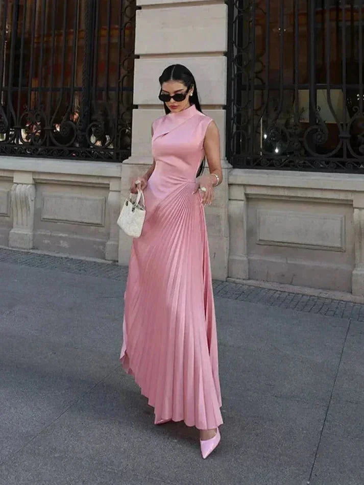 "Sleeveless pink maxi dress featuring pleated detail, ideal for summertime, made from a lightweight and breathable fabric…