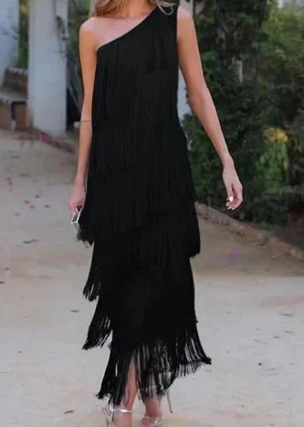 "Black women's asymmetrical dress with fringe, flowy design, perfect for casual or special occasions."