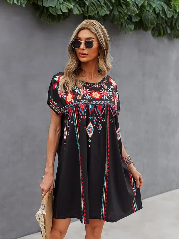 Embroidered boho dress with relaxed fit, featuring intricate floral designs on soft cotton fabric.