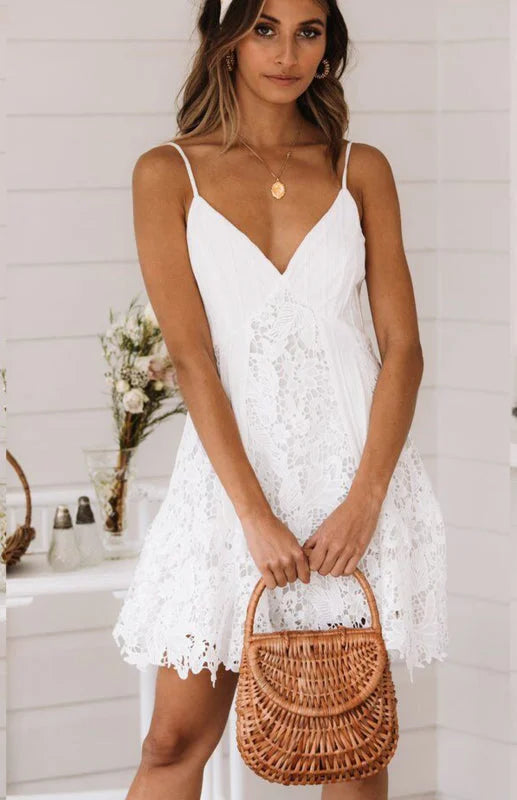 White v-neck mini dress with elegant lace detailing. Feminine and stylish, perfect for any occasion.