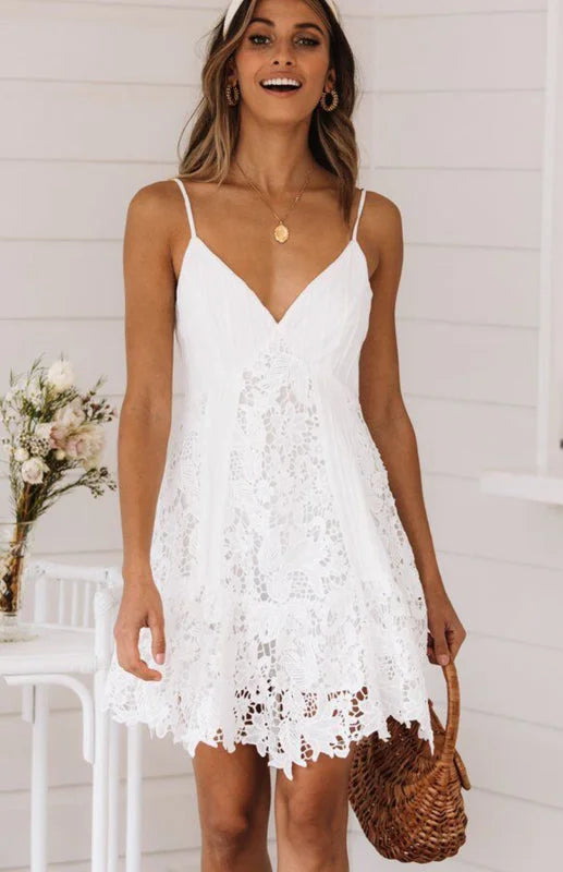 White lace mini dress with a flattering v-neck design, perfect for a chic and elegant look.