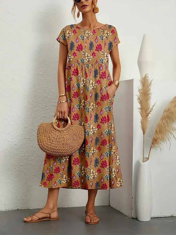 A breathable cotton midi dress featuring a lovely floral design by Dunya.