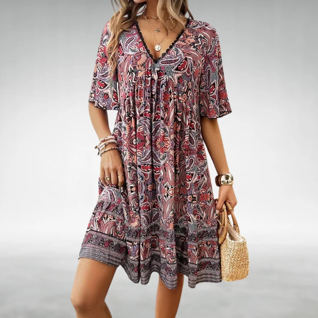 Red Bohemian style dress with paisley design made from soft, flowing fabric. Ideal for a relaxed, chic look.