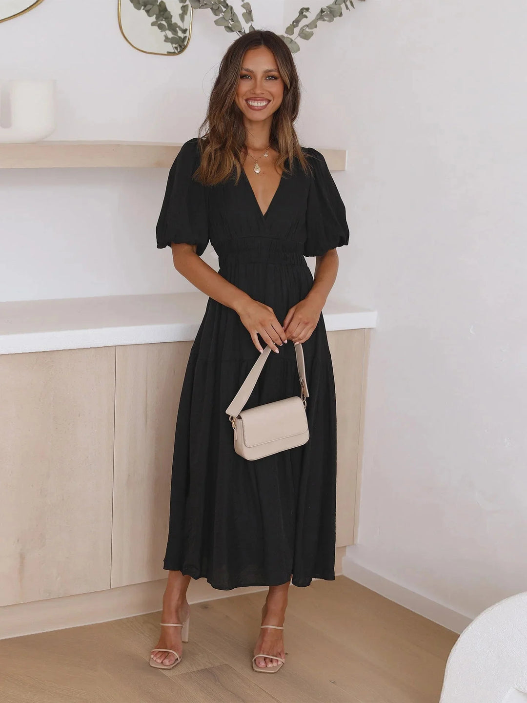 Black flowy dress with elastic waist and puff sleeves, perfect for all occasions. Made with lightweight and breathable…
