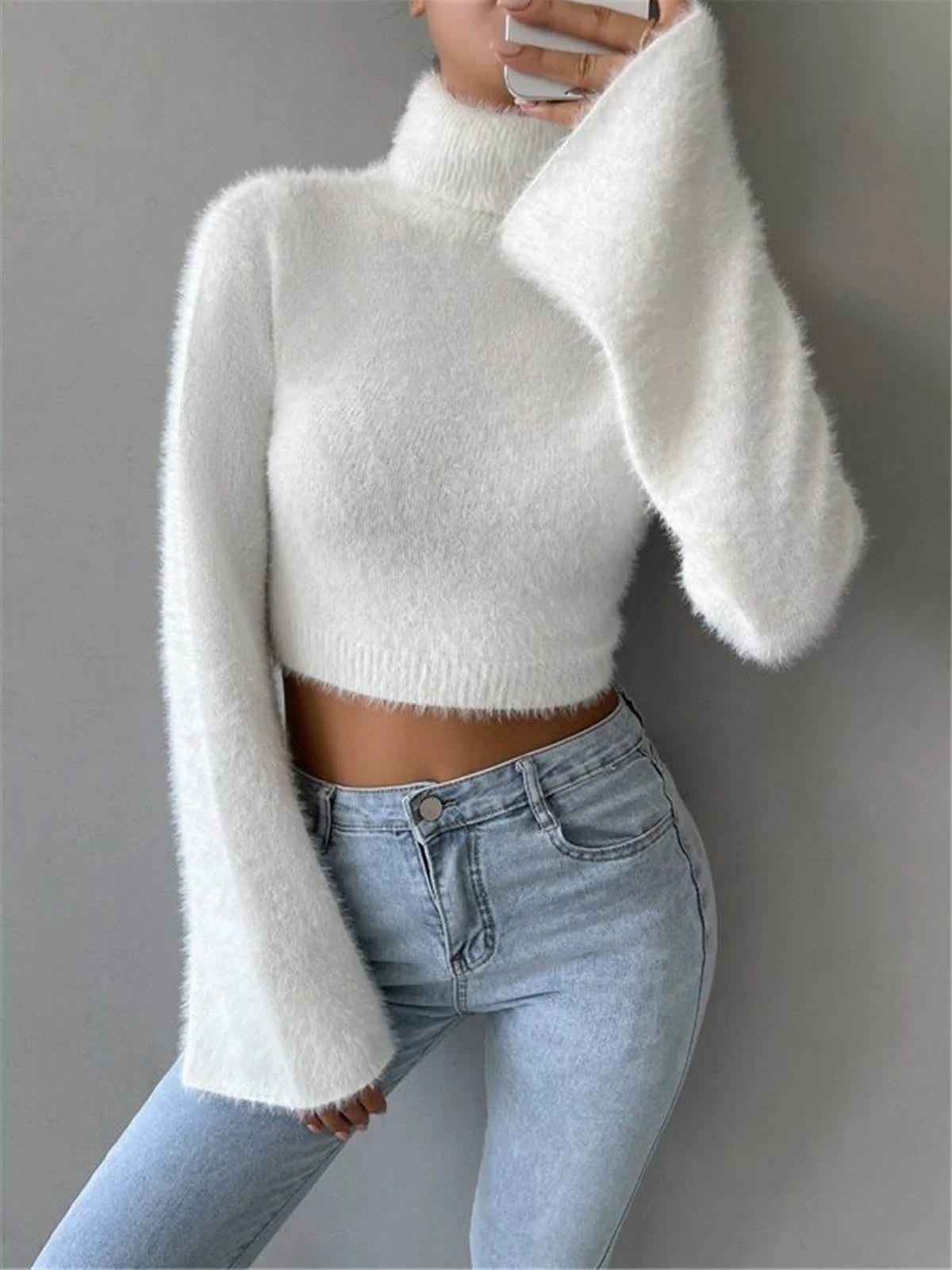 Cropped high neck fluffy sweater in soft knit material with textured finish. Features a cozy and chic design perfect for…