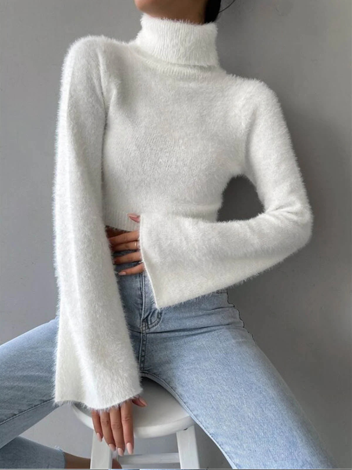 Soft and cozy cropped high neck sweater in a fluffy knit fabric by Eleia. Perfect for warm and trendy winter outfits.