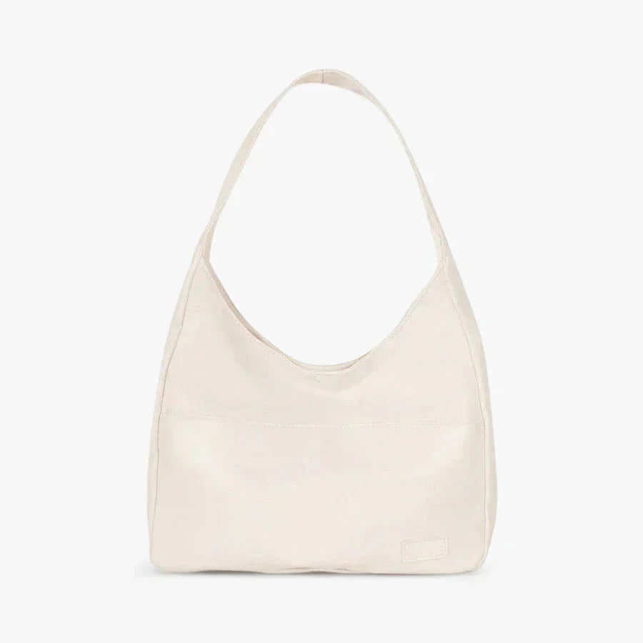 "White Eliette shoulder bag with sleek, modern design and generous compartment space, ideal for everyday use."