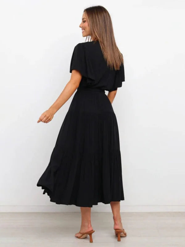 Black belted V-neck midi dress with flutter sleeves, made of stretchy fabric. Feminine and elegant for any occasion.