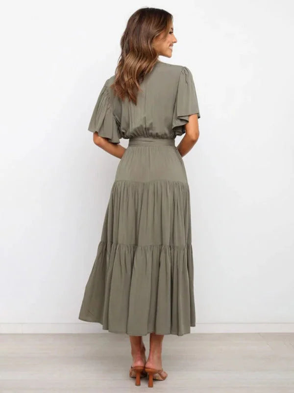 Black midi dress with flutter sleeves, belted V-neck design. Made from soft, flowy fabric. Perfect for casual or dressy…