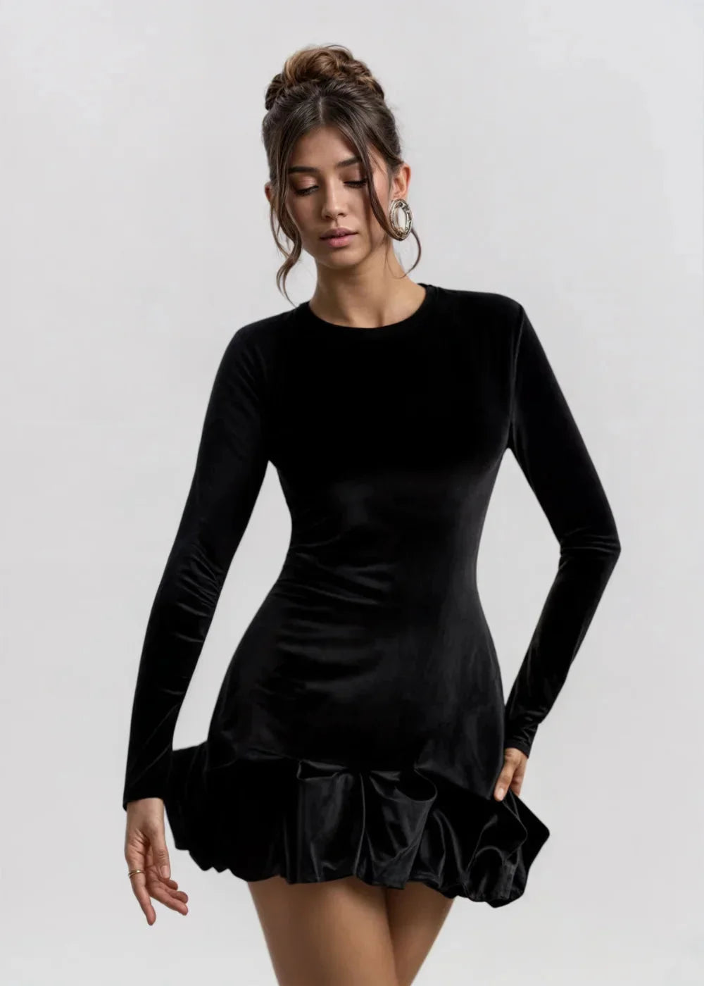 Women’s Black velvet dress with chic ruffles, elegantly styled for a sophisticated look.