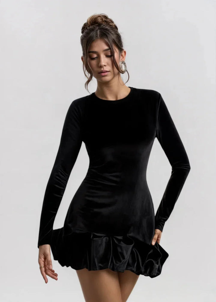 Women’s Black velvet dress with chic ruffles, elegantly styled for a sophisticated look.
