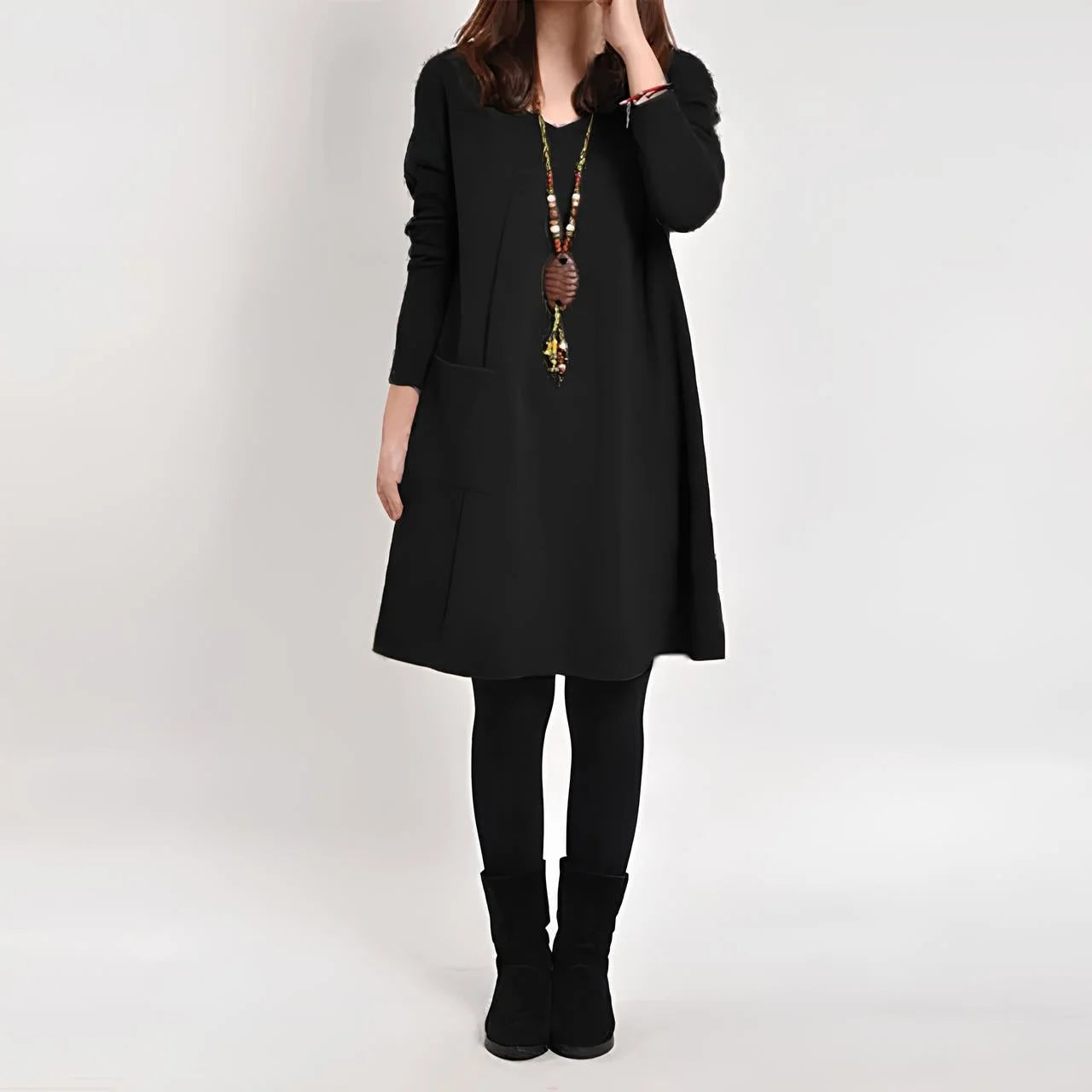 Black shift dress with functional pockets, perfect for everyday wear. Made from comfortable and durable fabric.