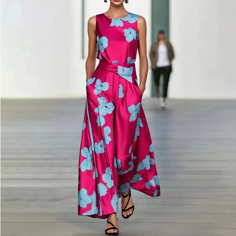 "Sleeveless pink maxi dress with blue flower pattern, made of lightweight breathable fabric, perfect for summer gatherings…