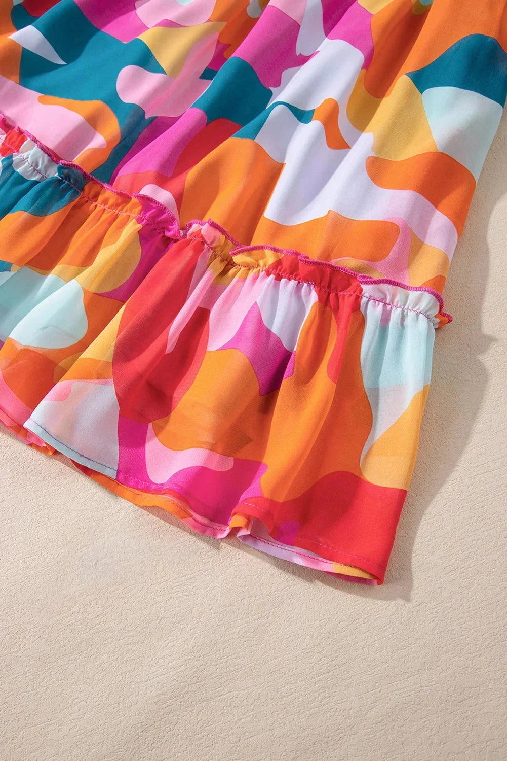Estefani women's V-neck dress with vibrant bell sleeves in a playful print.
