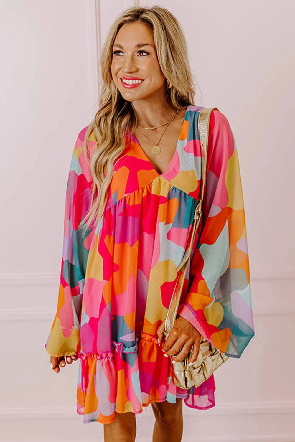 "Women's V-neck dress with vibrant bell sleeves, bohemian-style pattern, and flowing silhouette by Estefani"
