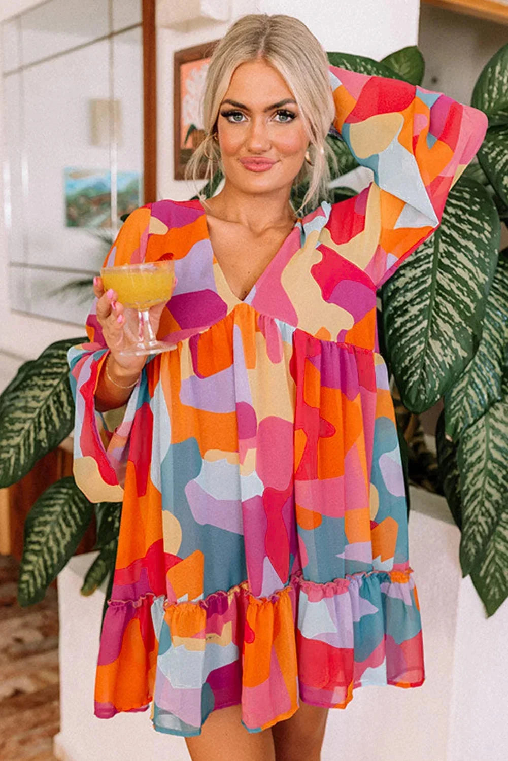 "Women's vibrant bell-sleeve V-neck dress, featuring a colorful design and flowing silhouette, perfect for a stylish and…