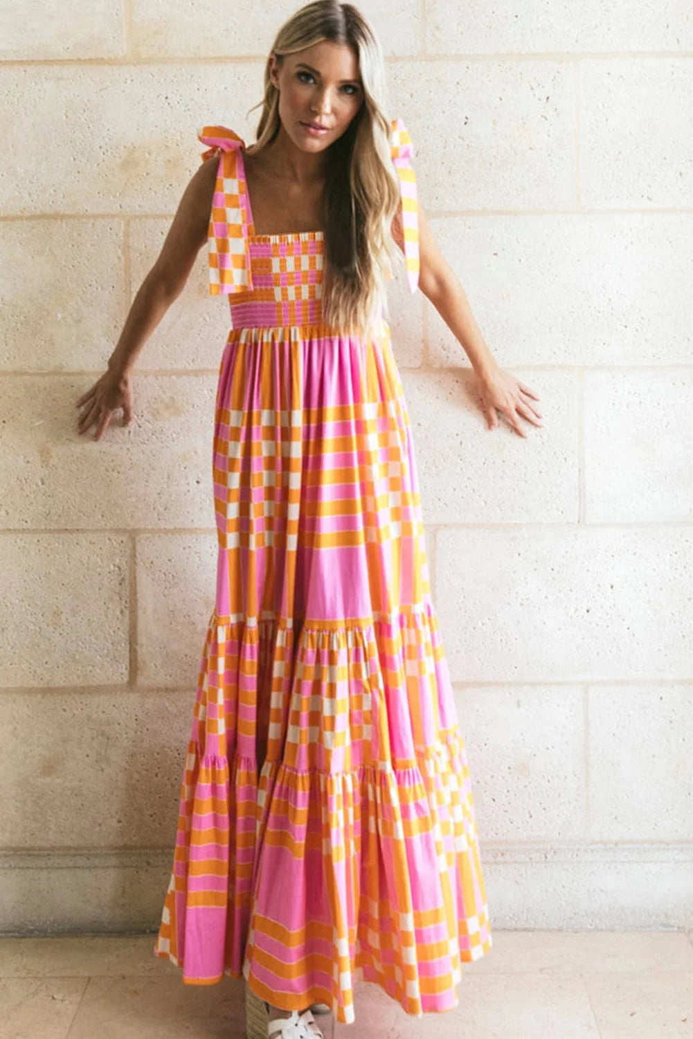 Pink orange gingham smocked maxi dress with a flowy silhouette, ideal for sunny days.