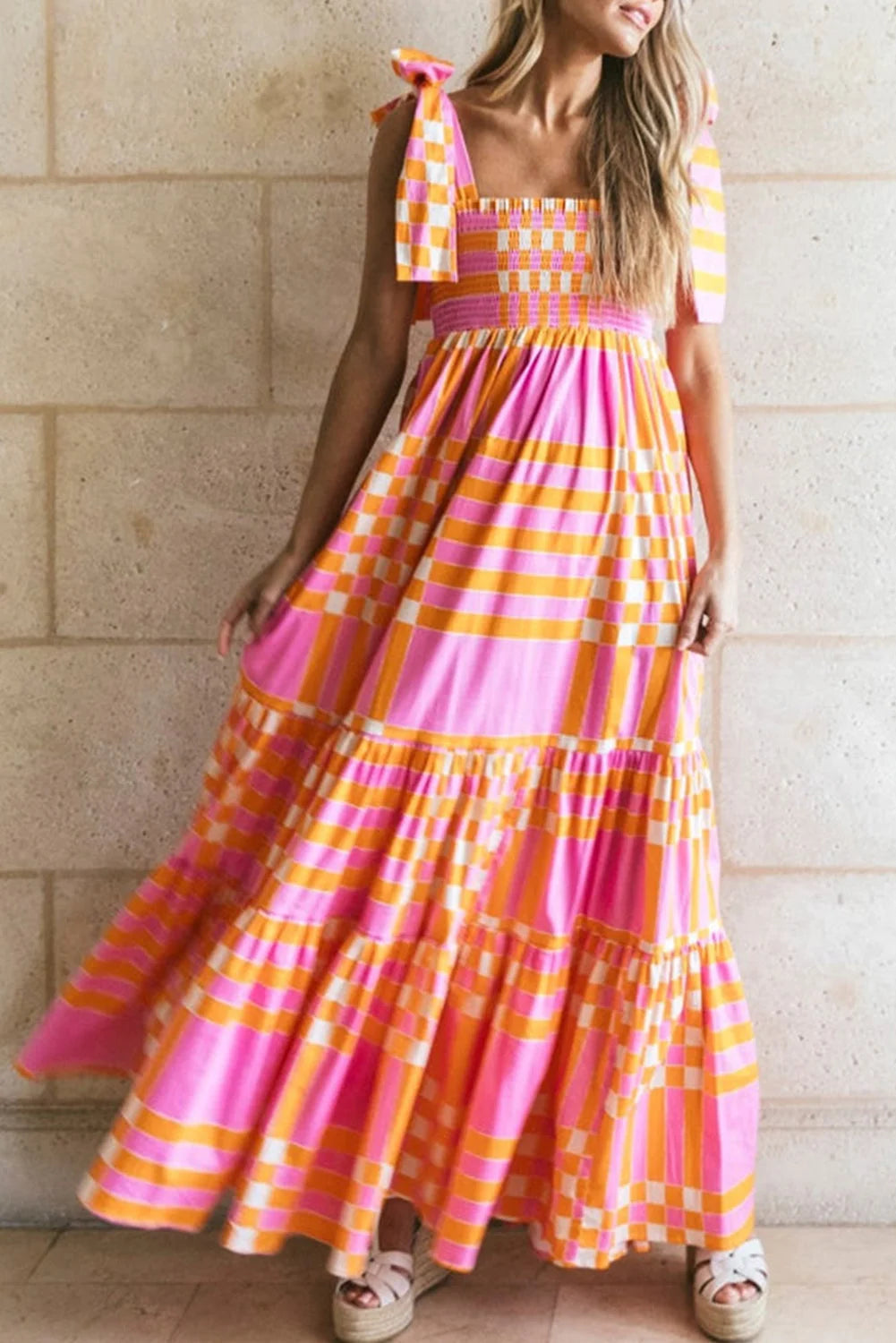 Pink and orange gingham smocked maxi dress in Evan style, perfect for a summer day out with its vibrant colors and…