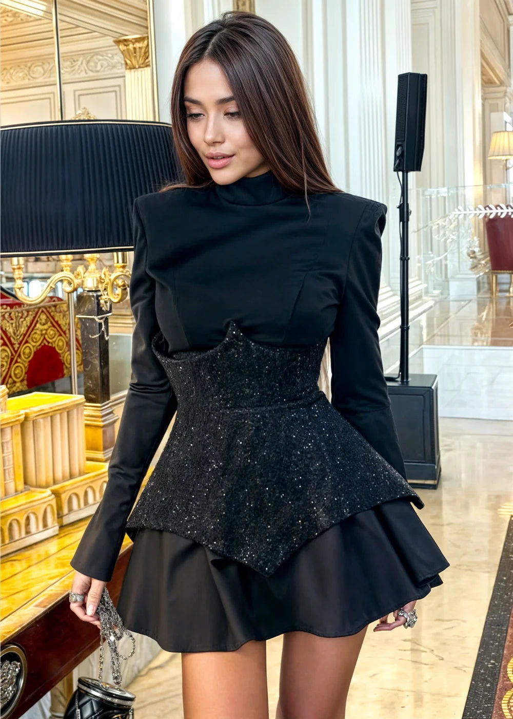 "Black sequin peplum-style mini dress with a sleek design and striking sparkle detail."