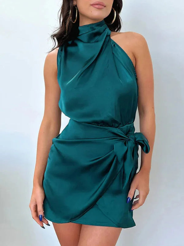 Deep green halter mini dress with draped front and tie waist by Fatema. Made of soft and flowy fabric for a flattering fit.