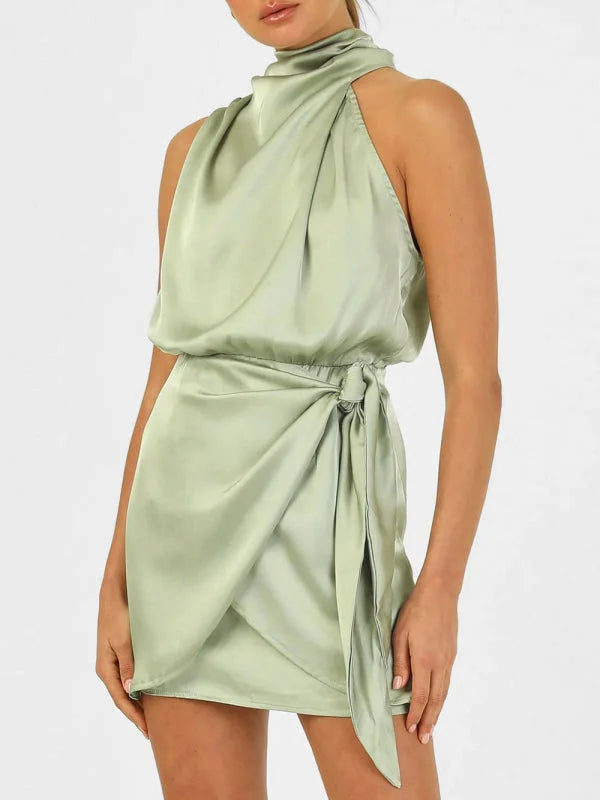 Pale green halter mini dress with draped front and tie waist, perfect for a breezy and stylish look.