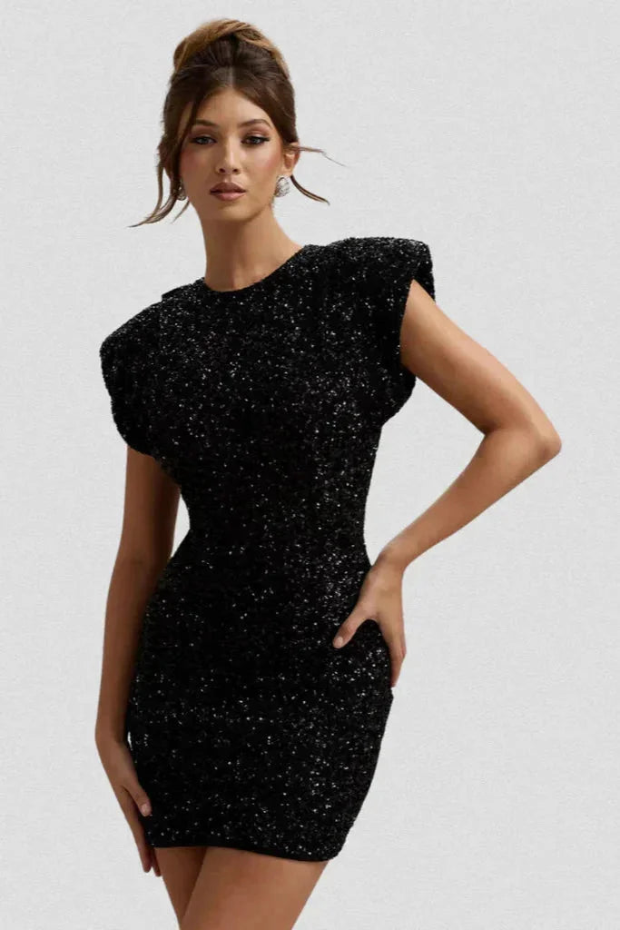"Women’s fitted dress in black with bold shoulder pads, made of stretchy fabric. Stylish design for a confident look."