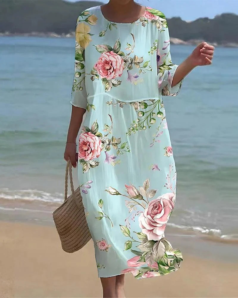 Floral print midi beach dress with lightweight polyester fabric and vibrant design perfect for summer days by the sea.