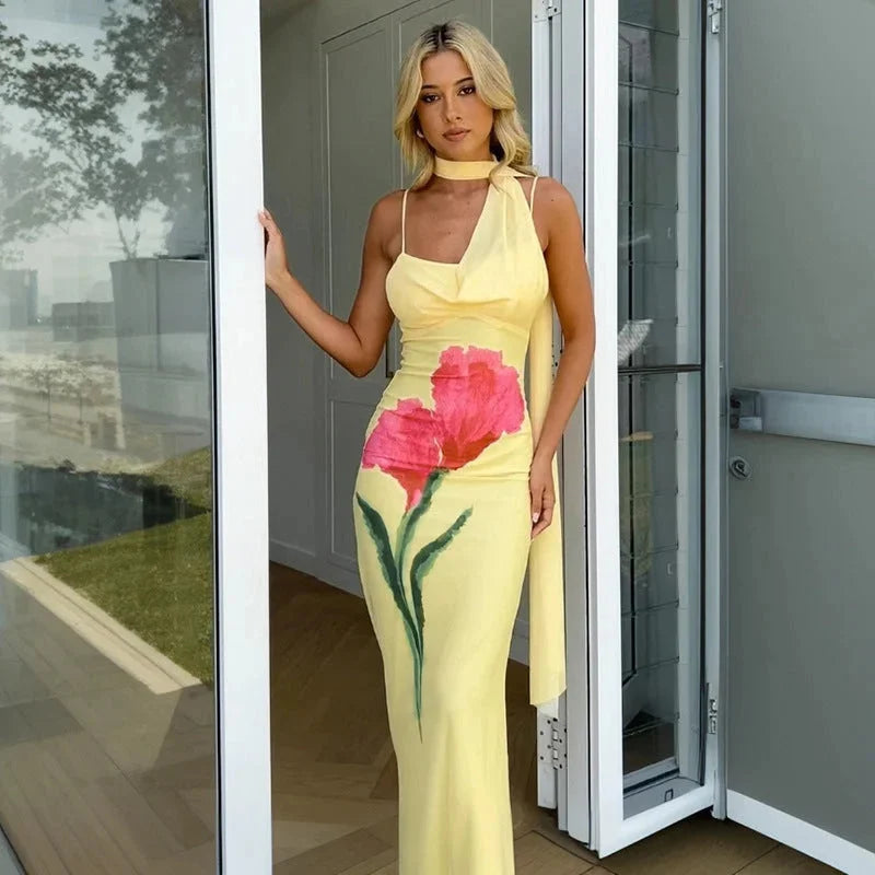 Yellow floral maxi dress with halter top for women, showcasing a vibrant floral pattern on a flowy silhouette, perfect for…