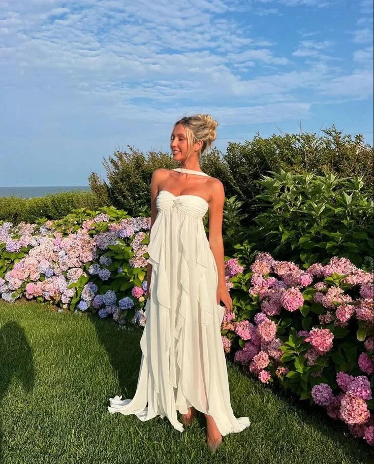 Strapless maxi dress in soft fabric with cascading ruffles, perfect for elegant occasions.